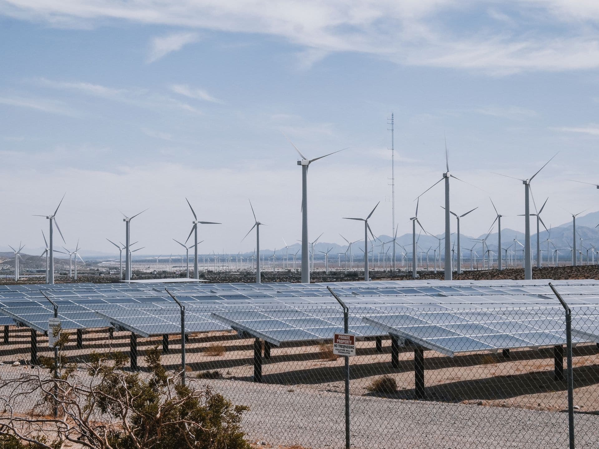Solar panels and wind turbines at a working renewable energy plant